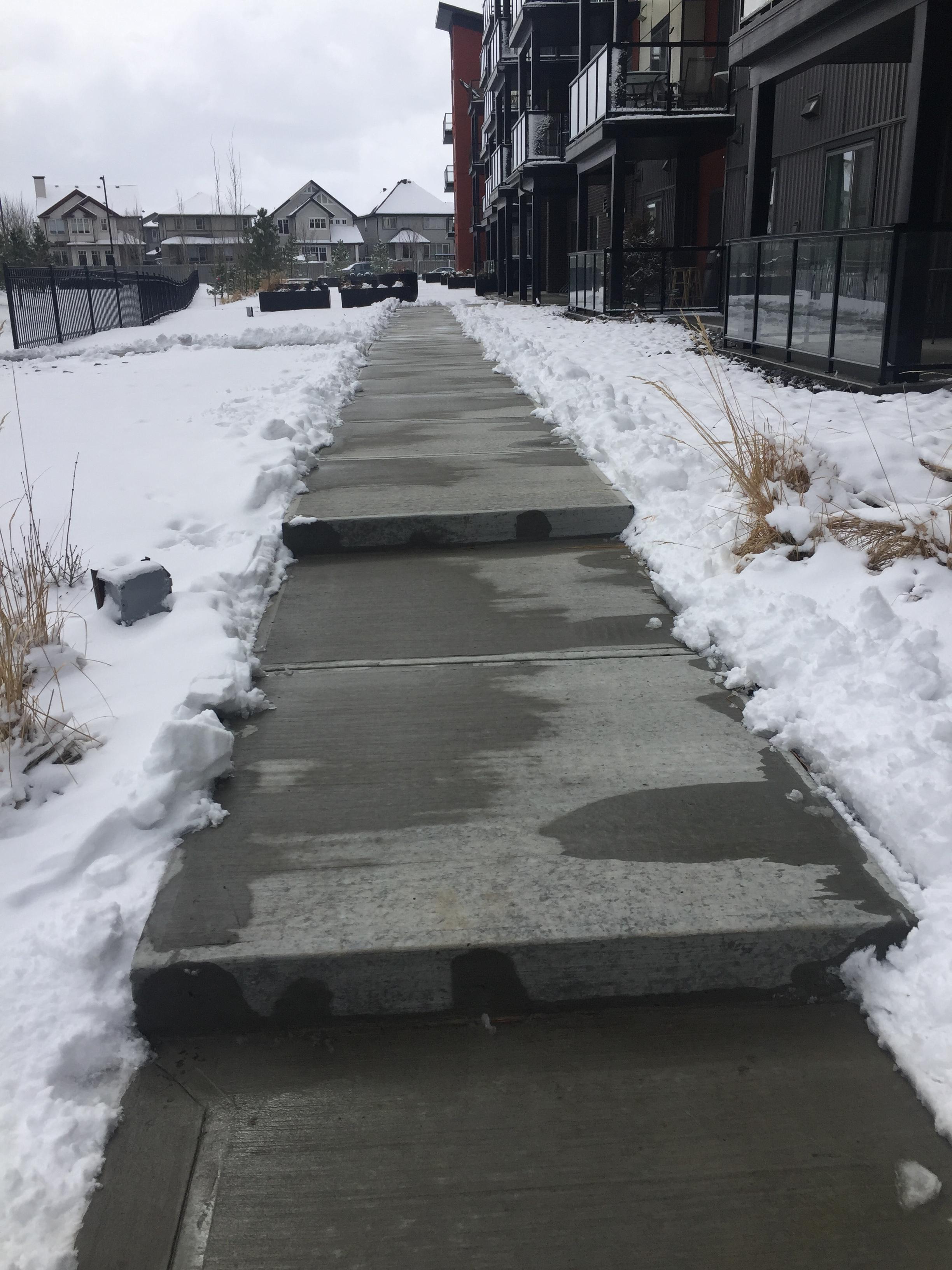 Elevated stair steps cleared in front of apartment building